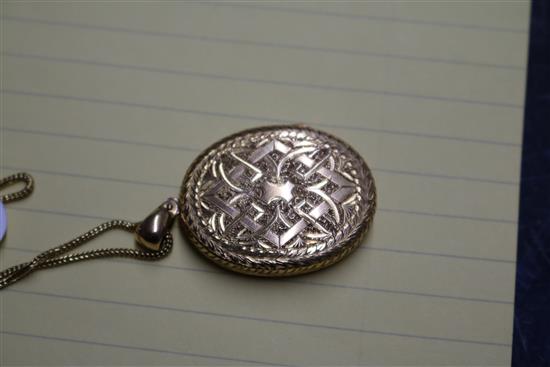 A Victorian engraved yellow metal oval locket, on a 9ct gold chain, locket 37mm.